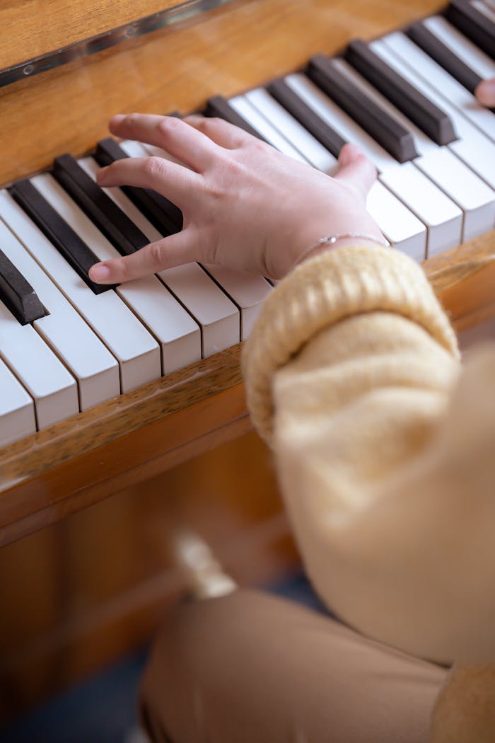 gallery-4 From above of crop anonymous female musician playing piano while practicing classical music